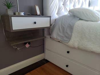 reviewer photo of floating nightstand next to bed