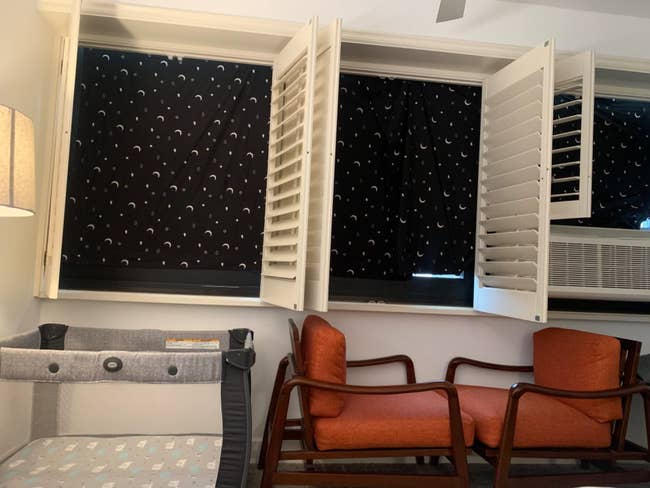 hotel room with shades over windows under shutters