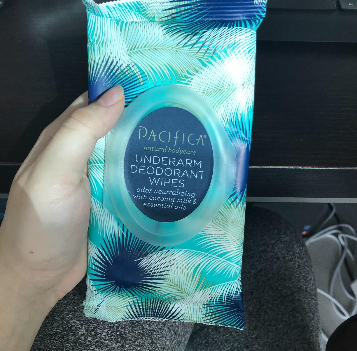 Reviewer holding a pack of the wipes