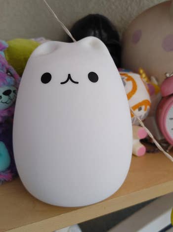 a reviewer photo of the cat-shaped lamp turned off 