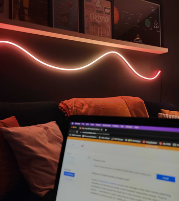 the rope light on a wall under a shelf