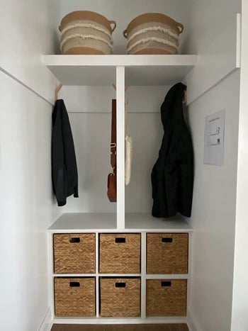 six baskets organized under a coat rack