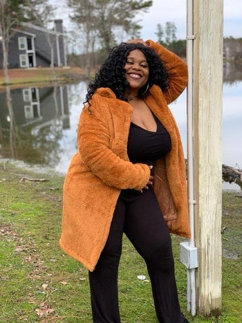 model in the caramel colored teddy coat