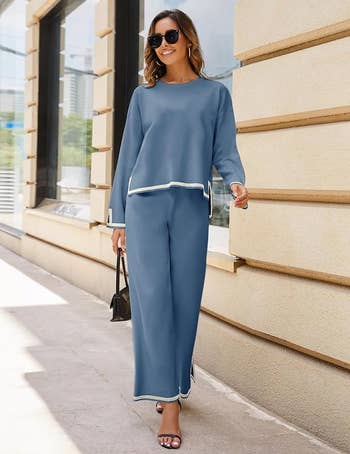 Woman in a casual blue loungewear set with a handbag, walking outdoors