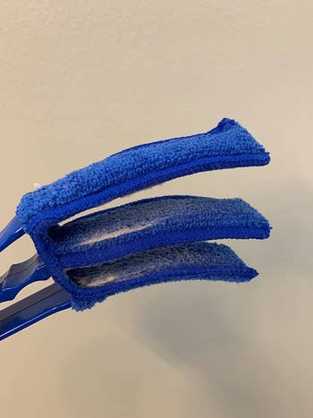 Reviewer photo of duster brush with blue cloths