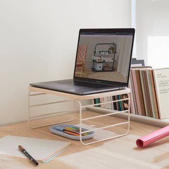 The shelf riser being used as a laptop stand