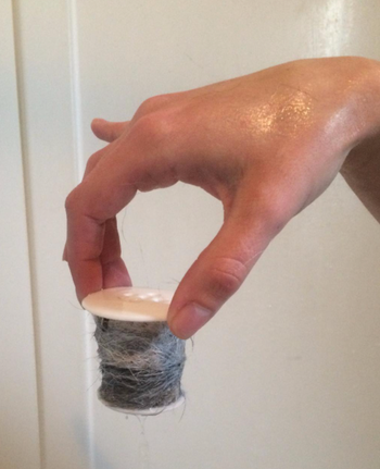 reviewer holding product up wrapped in wet hair 