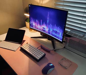 Reviewer's laptop, keyboard, and mouse on waterproof desk pad