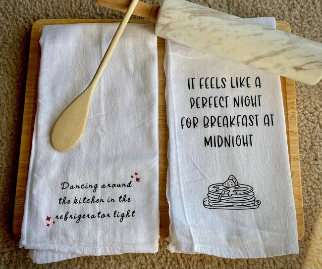 Image of two white towels with Taylor Swift lyrics