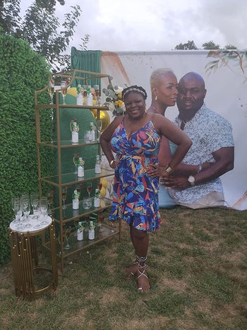 A different reviewer wearing the dress in a floral pattern