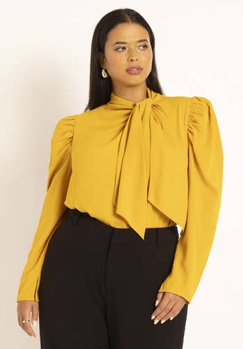 a model wearing the same blouse in yellow 