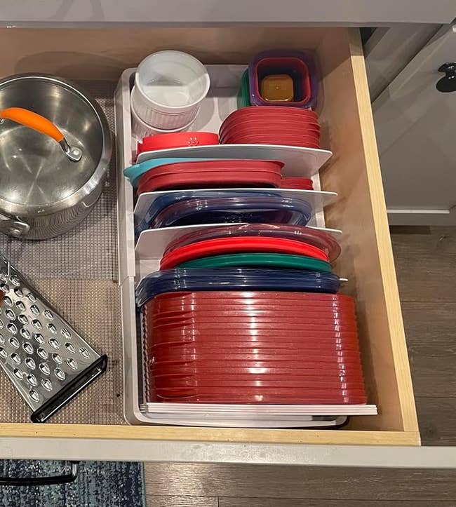 reviewer's drawer with several Tupperware lids in the organizer
