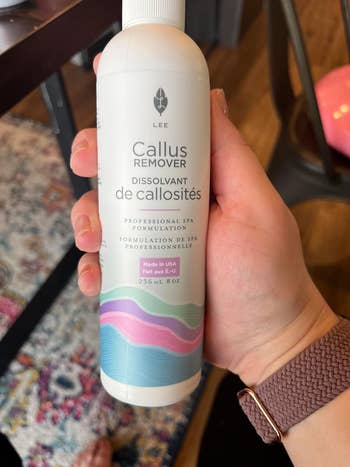 reviewer holding a bottle of Callus Remover, labeled as a professional spa formulation, suitable for personal care and beauty purposes