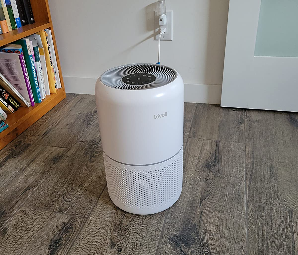 reviewer image of the white air purifier on a wooden floor
