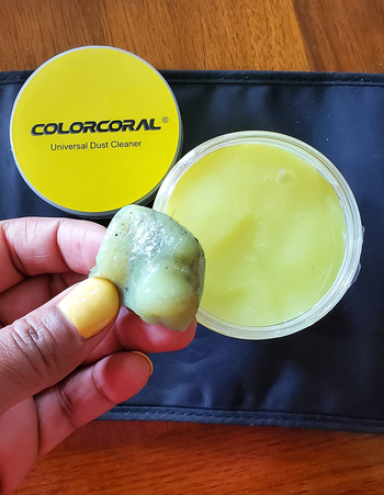 a hand showing some of the dirt picked up while cleaning with the gel