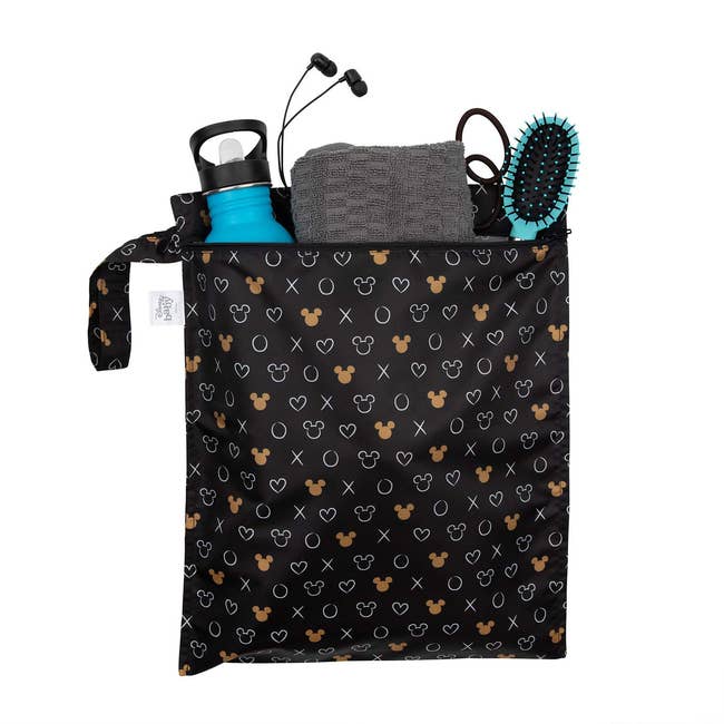 The wet bag in Minnie Mouse Icon print holding essentials