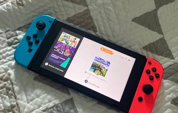 reviewer's handheld gaming console with red and blue detachable Joy-Cons