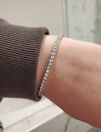 reviewer in a silver plated faux diamond tennis bracelet 