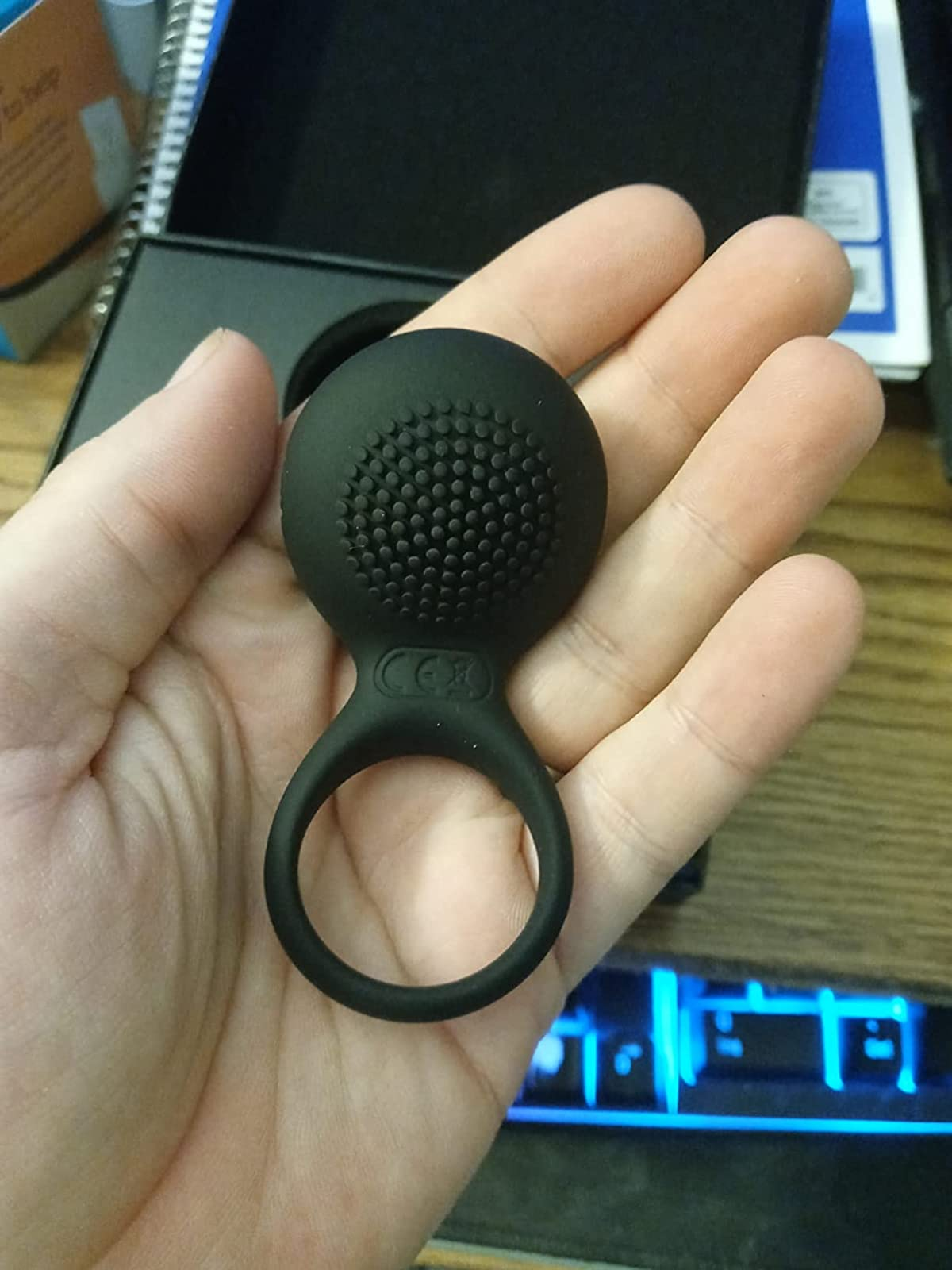 Reviewer displaying black textured side of cock ring