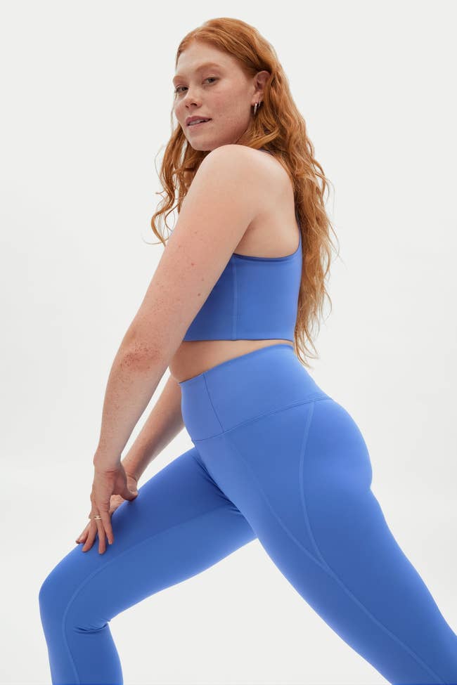 a model in bright blue leggings