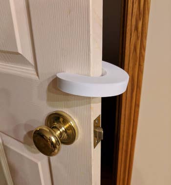 a reviewer photo of the pinch guard installed on a door near the knob