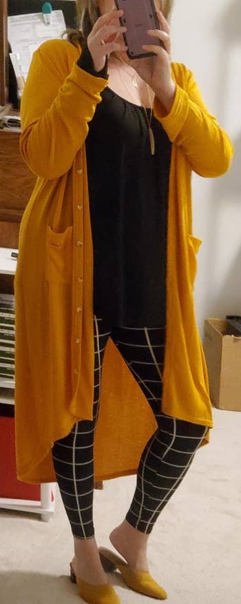 a reviewer wearing the cardigan in yellow 