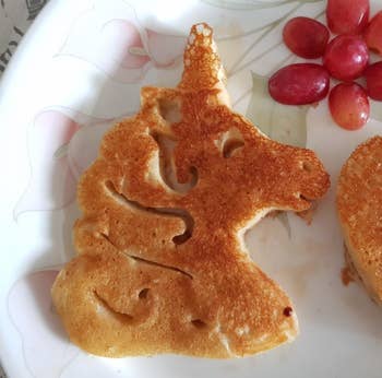 A fully cooked unicorn pancake on a plate 