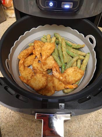 Fried shrimp and green beans in an air fryer, ready to serve