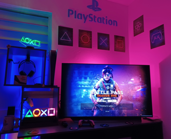 reviewer's gaming setup with the prints above the tv