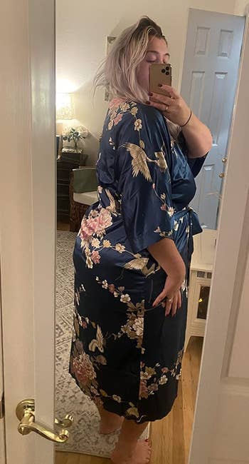 a reviewer wearing the long kimono robe in navy with a floral print 