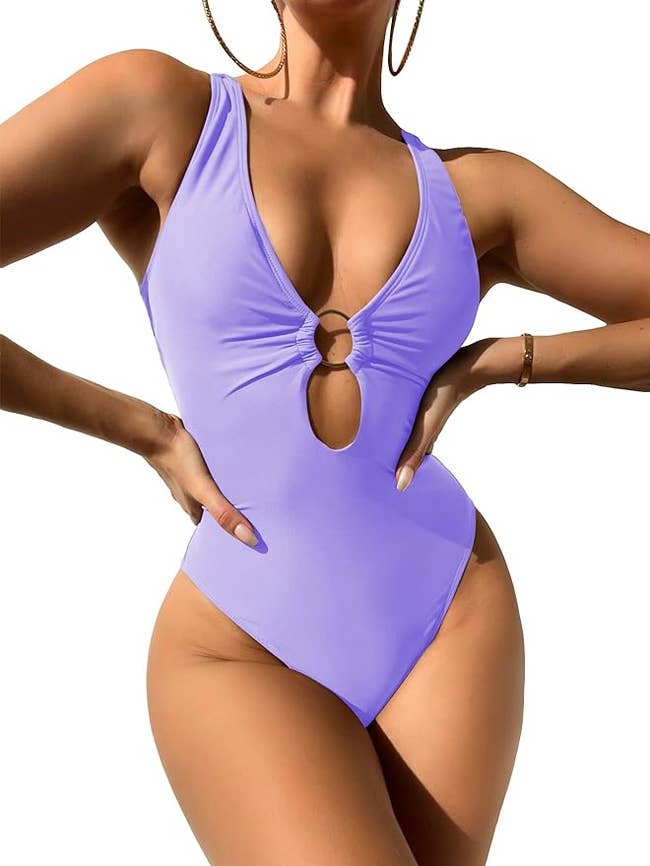 Model wearing a one-piece swimsuit with a keyhole cutout, suitable for shopping swimwear