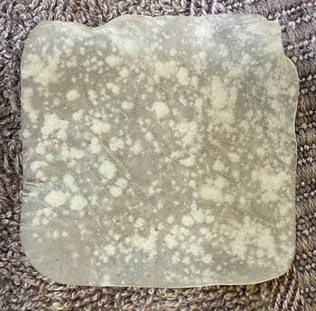 a reviewer photo of a large acne patch with white spots all over it 
