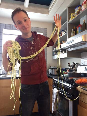 a reviewer holding a large pile of zucchini spiralized noodles