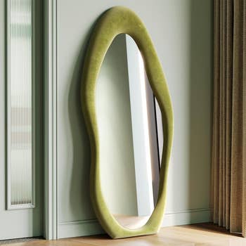 Full-length mirror with unique wavy frame, ideal for home decor