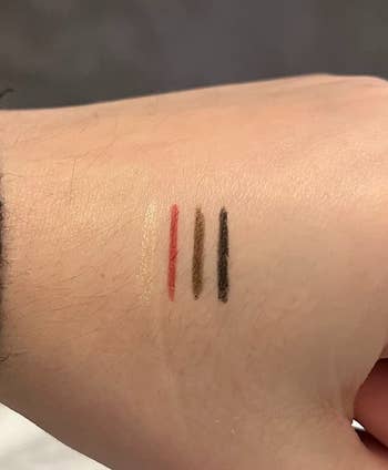 A swatch of the highlighter, lipliner, eyeliner, and brow liner