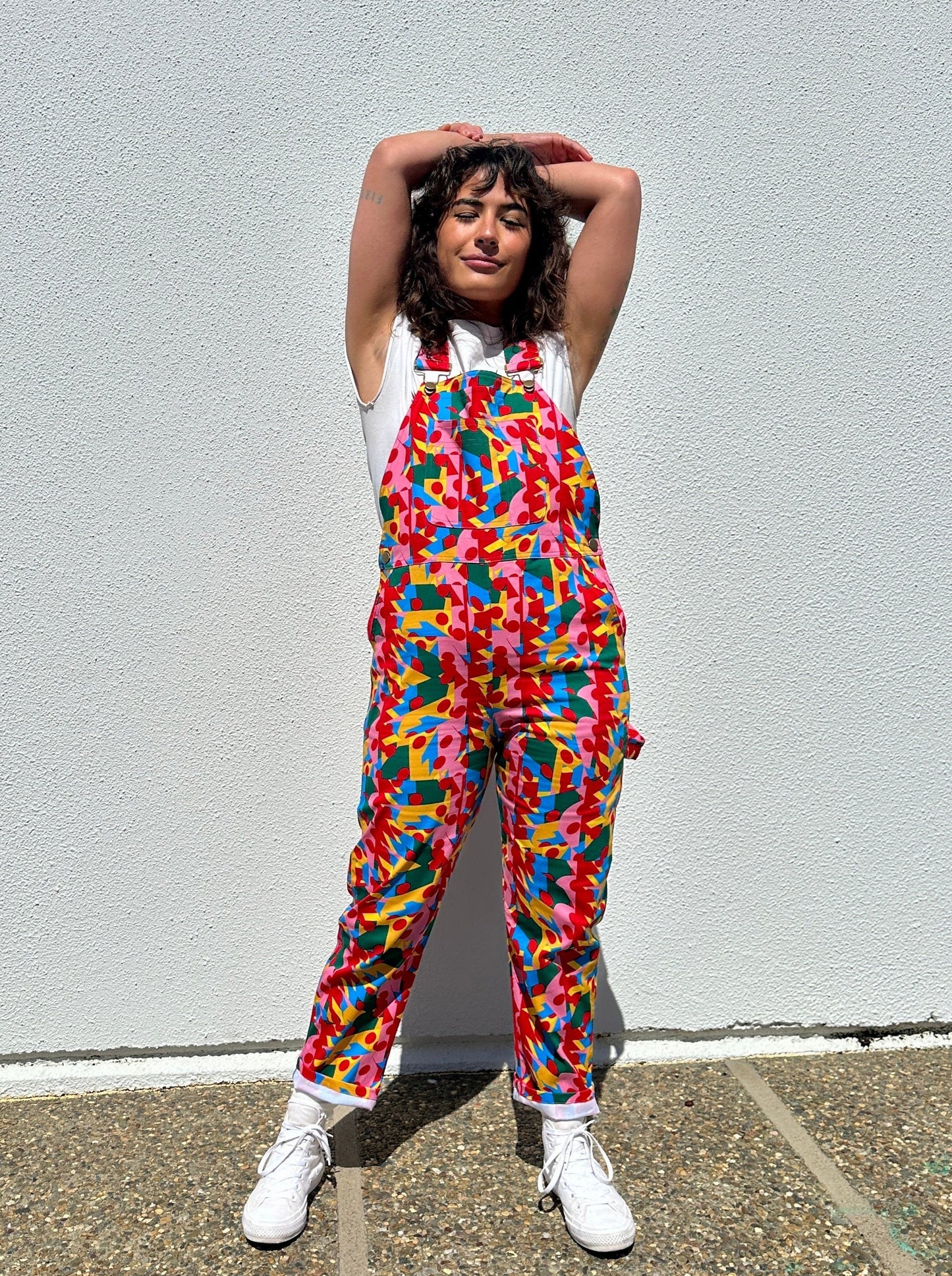 model in overalls in colorful geometric print