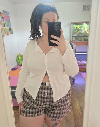 different reviewer taking a selfie wearing the shorts successful multi-coffee plaid
