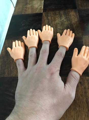a reviewer with a tiny hand on each of their five fingers
