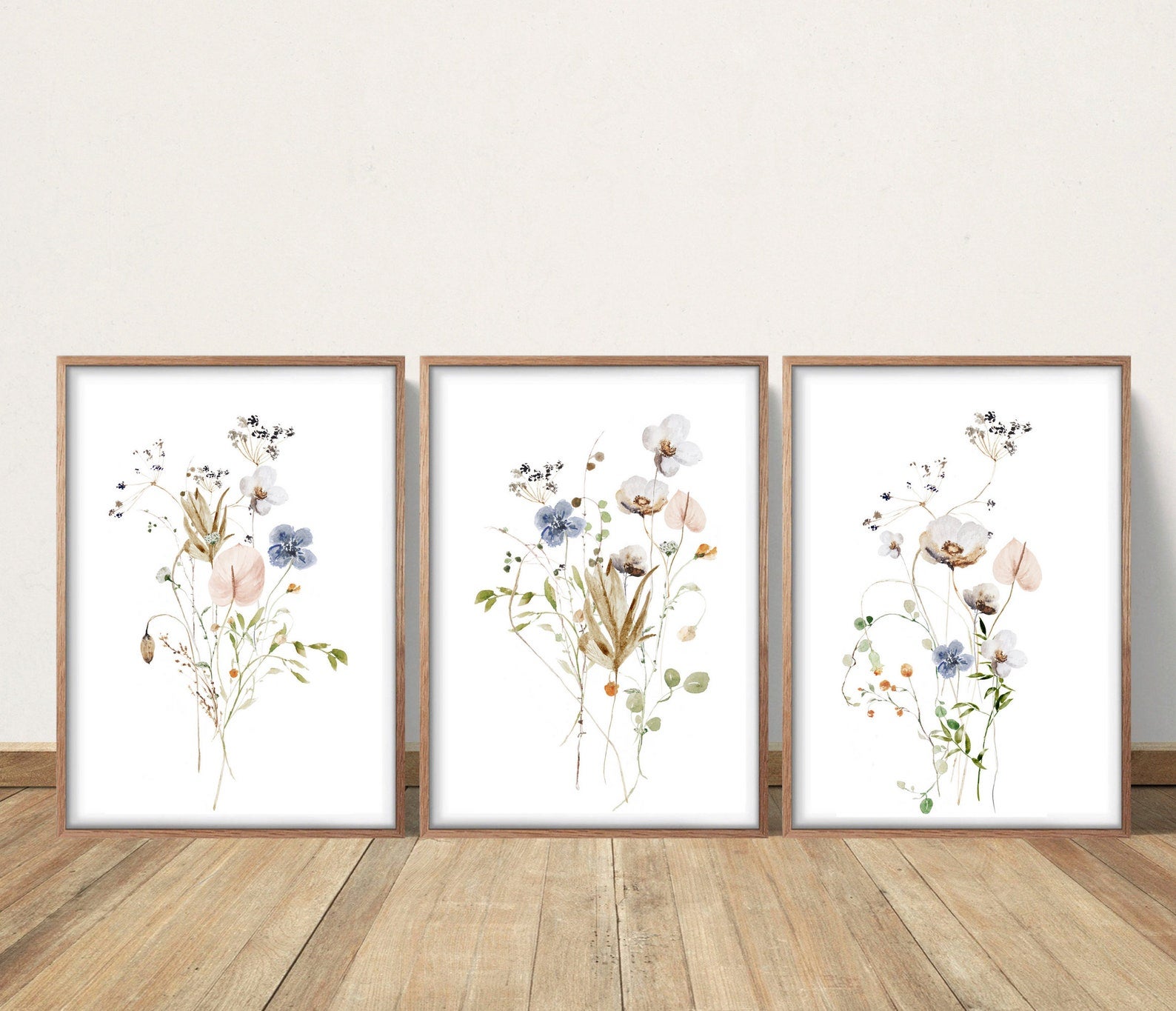 Three paintings of pastel flowers against a white background 