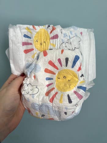 a diaper with cute sun and cloud designs on it