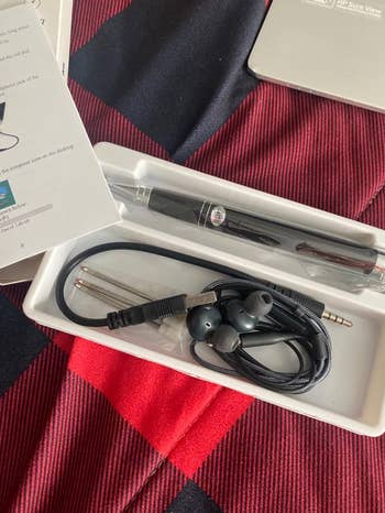 The pen in a kit with headphones and a USB cord
