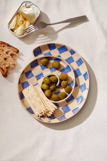 close up of the plate with olives and crackers on it 