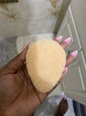 reviewer holding buf puf gentle facial sponge