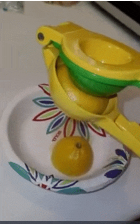 Reviewer clamping down on hand held squeezer to extract fresh lemon juice