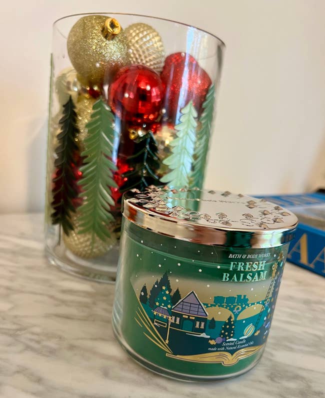 a fresh balsam scented bath and body works three wick candle with a wintry scene on it