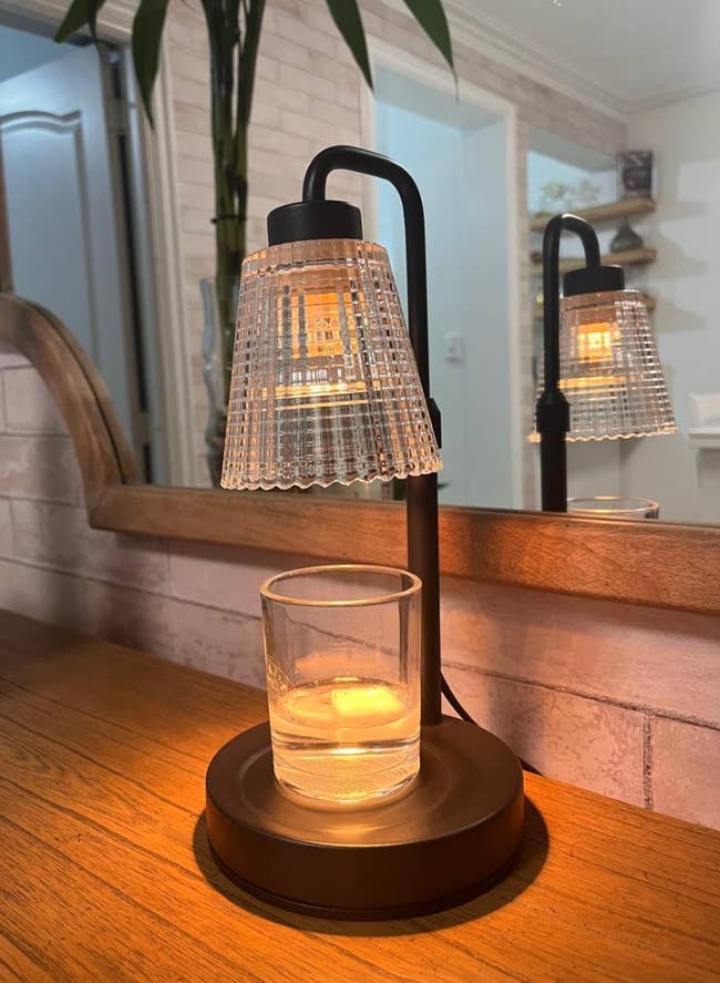 Modern lamp with a textured shadiness illuminating a solid of h2o connected a woody surface, creating a cozy ambiance