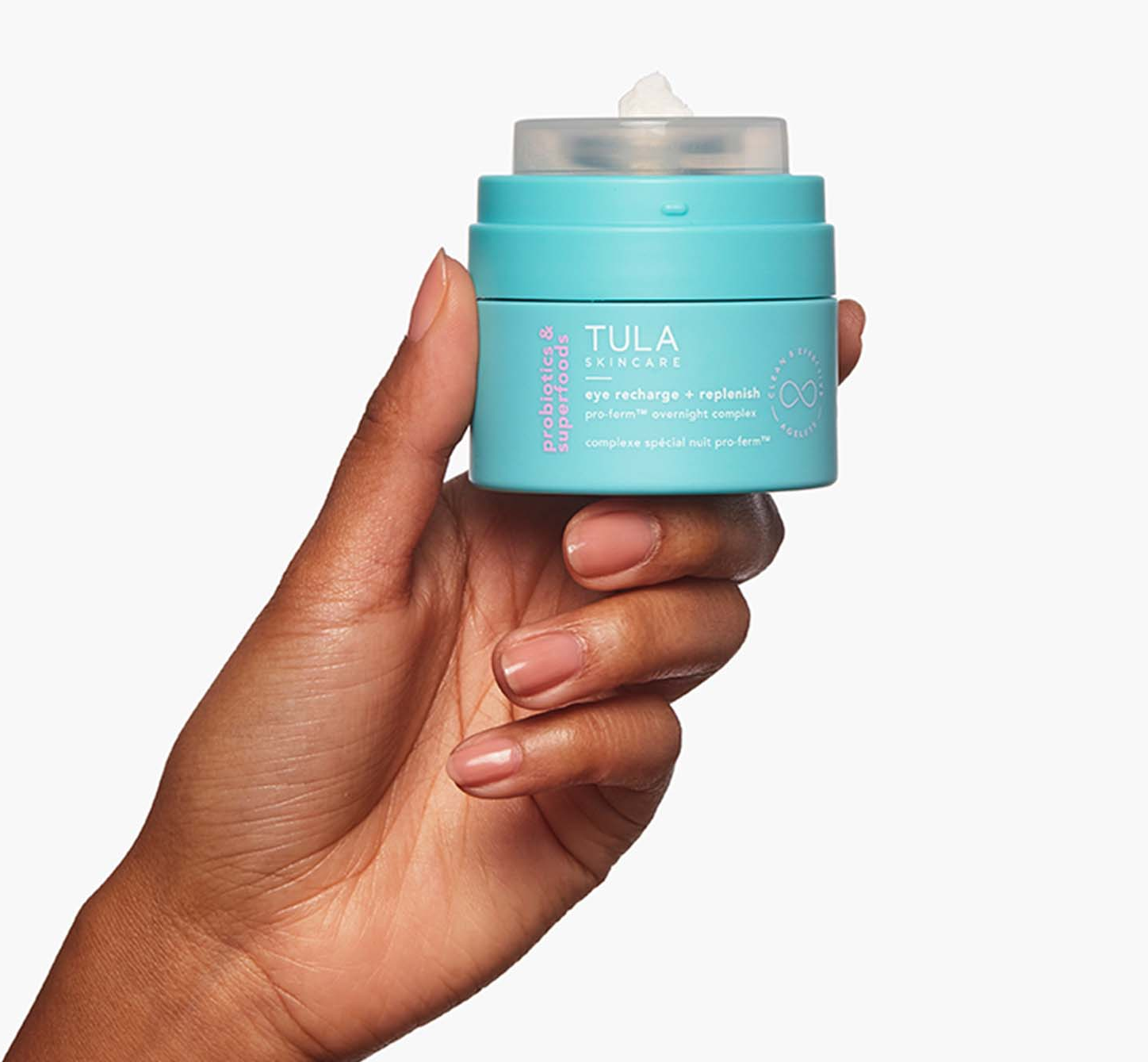 A model holding a jar of Tula eye cream