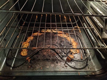 reviewer before image of the inside of an oven with dark stains and caked on food