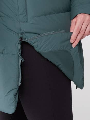 model showing a close up of the side slit in the parka