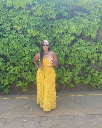 reviewer posing in yellow crop top with matching maxi skirt